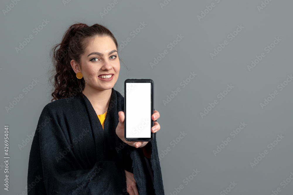 Wall mural emotional young woman showing smartphone with empty touch screen with copy space