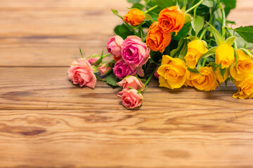 Beautiful pink, orenge and yellow roses flowers on the floor.