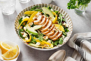 Easy Grilled Chicken breast salad with mango and avocado slices, sprinkled with walnuts and feta...