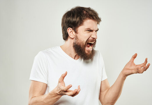Aggressive man gestures with his hands thick beard irritability stress