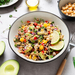 Healthy quinoa black bean salad with mango and avocado. Perfect for spring, summer, fall or winter. Gray stone background.	