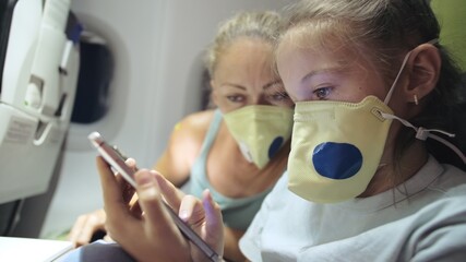 Family woman and child baby travel tourist caucasian at plane aircraft with wearing protective...