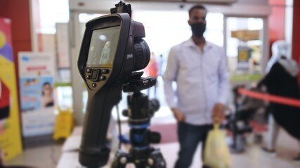 Temperature check at a supermarket, grocery store with a thermal imaging camera installed. Coronavirus pandemic outbreak.