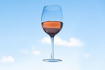 glass of red wine against blue sky