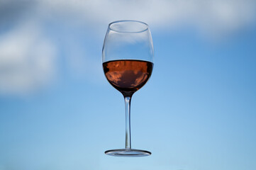 glass of red wine against blue sky