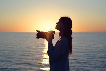 woman photographer with professional camera landscape sunset fresh air