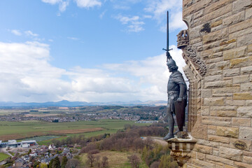 William Wallace statue stands proudly.The National Wallace Monument is a tower standing on a hilltop in Stirling in Scotland.It commemorates Sir William Wallace, a 13th and 14th-century Scottish hero. © Jacek