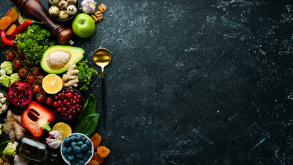Healthy food background. Concept of Healthy Food, Fresh Vegetables, Nuts and Fruits. On a stone background. Top view. Copy space