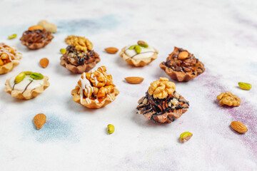 Various homemade mini tartlets with nuts and chocolate cream.