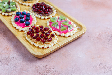 Homemade desserts with blueberries,kiwi slices and pomegranate seeds.