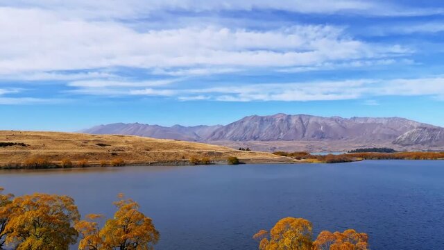 time lapse, autumn Lake Alexandrina, distant mountains, white clouds in blue sky