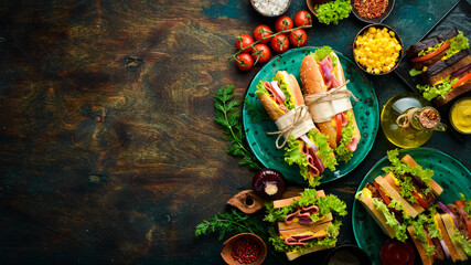 Breakfast. Classic sandwiches with sausage, cutlet, lettuce, onion, tomatoes and vegetables. Rustic...