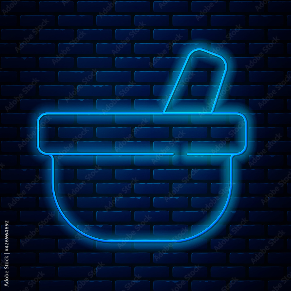 Sticker Glowing neon line Mortar and pestle icon isolated on brick wall background. Vector