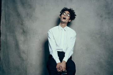 happy guy with glasses white shirt pants photography studio posing model