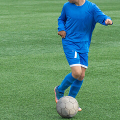 Children's football. Children are playing football. The active struggle and dynamics of the boys' soccer match. The boys are recklessly fighting for the ball
