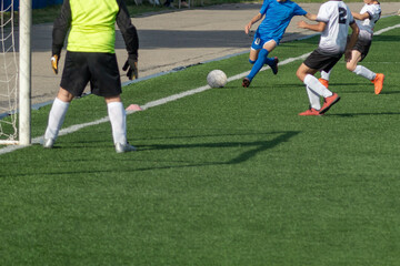 Children's football. Children are playing football. The active struggle and dynamics of the boys' soccer match. The boys are recklessly fighting for the ball