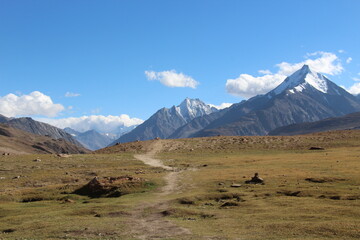 Fototapeta premium Landscape of the Himalayan peaks with a trail leading towards the mountains