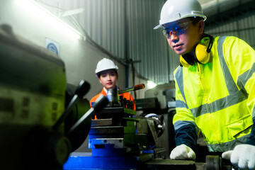 engineer cooperation Two asian maintenance engineers men and women inspect relay protection system...