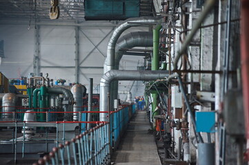 Petropavlovsk, Kazakhstan - 05.26.2015 : The territory of the power plant with large industrial compartments for turbine generators and pipes.
