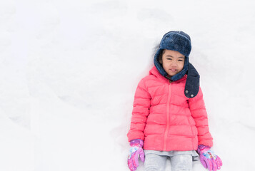 Fototapeta na wymiar Happy girl plays with a snow in sunny winter day