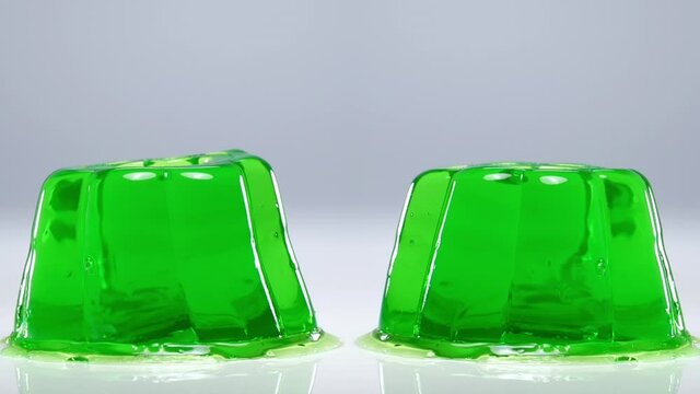 Wobbly green jelly on white background. 