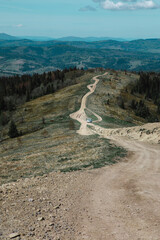 car travel concept suv driving by country road leading to the mountains