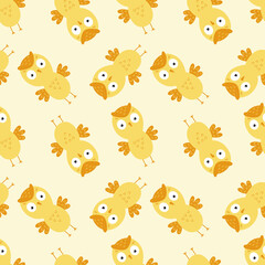 Seamless background with yellow owls for printing on baby fabric. Wallpaper with an owl for sewing children's clothing and packaging paper.