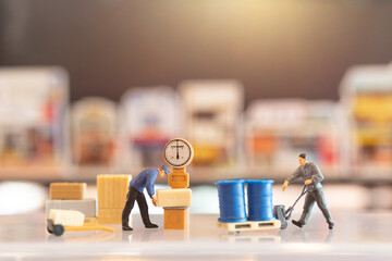 Miniature  people postman officer on duty, he prepares to send a box to consumer. delivery service for ecommerce concept