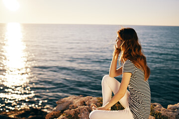 Fototapeta na wymiar woman in t-shirt and trousers portrait sea sunset sun