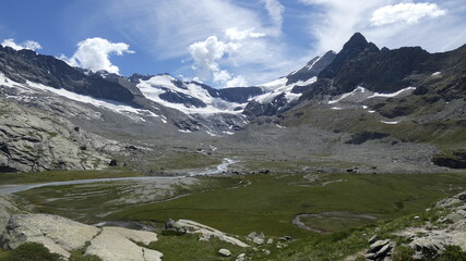 Mountainous valley under a cloudy summer sky