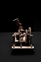 Model engine made of wood and plywood on a black background