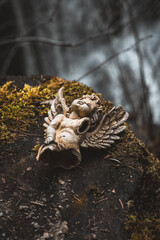 Broken sculpture of an angel in the mountains.