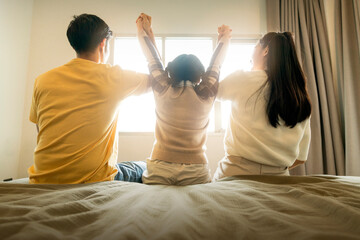 together forever love asian family hand together with morning sunlight flare from window on the bed...