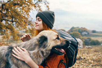 woman hiker hugging dog nature patriarch vacation