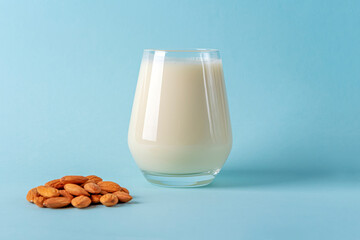 Glass of organic vegan dairy free milk from almonds nuts. Healthy breakfast with vegetarian...