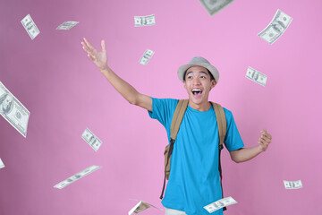 Happy Young Asian traveler man dreaming have much money, dreaming money falls from the sky