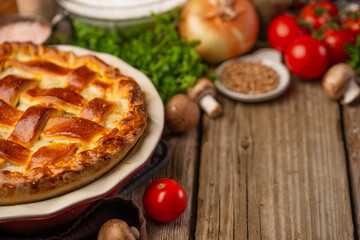Pie with mushrooms and meat top view with ingredients on a wooden table. with space for an inscription, culinary recipes