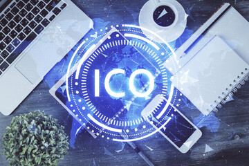 Double exposure of blockchain theme hologram over table with phone. Top view. Crypto technology concept.