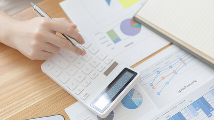 Accounting businesswomen are calculating income-expenditure and analyzing real estate investment data, Dedicated to the progress and growth of the company, Financial and tax systems concept.