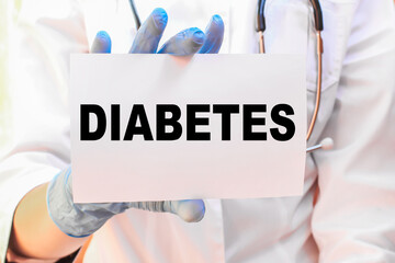 The doctor's blue - gloved hands show the word DIABETES - . a gloved hand on a white background. Medical concept. the medicine