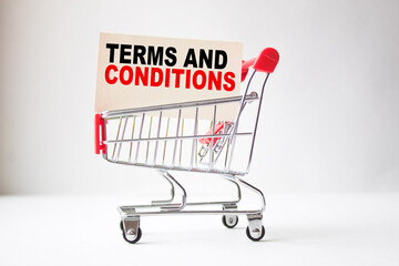 a business card with text TERMS AND CONDITIONS in a shopping cart. business and finance