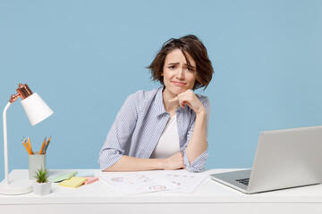 Young confused disappointed troubled sad secretary employee business woman in casual shirt sit work...