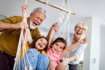 Family, generation love and people concept. Happy grandparent having fun with children at home