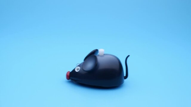 Clockwork mouse runs on a blue background. Seamless loop.