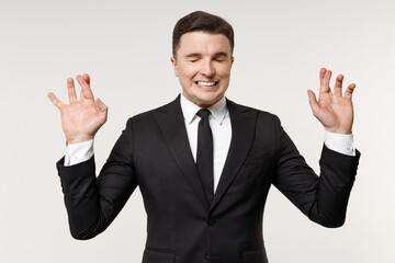 Young employee business corporate lawyer man in classic formal black grey suit shirt tie work in office wait special moment keep finger cross make wish eyes closed isolated on white background studio