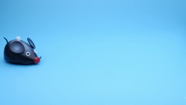 Clockwork mouse runs on a blue background. Seamless loop.
