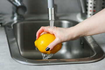 washing lemons in the sink
