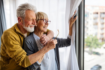 Happy senior couple in love hugging and bonding with true emotions