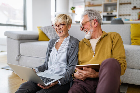 Happy romantic senior couple hugging and enjoying retirement at home