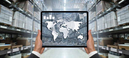 Hands with digital tablet on the background of a warehouse. Online trade and logistics concept